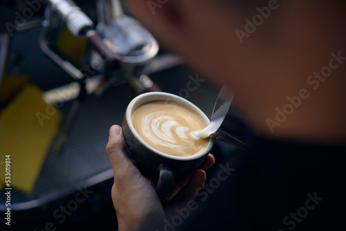 men s hands pouring milk and preparing fresh cappuccino  coffee pot and cooking concept  morning coffee
