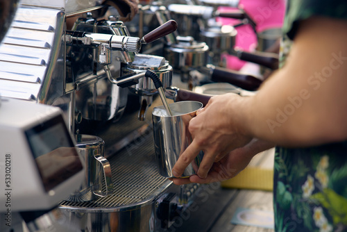 close-up image of the coffee machines that are operating automatical Coffee flowing into coffee cup that is prepar for service Coffee aroma bake the whole shop and the shop atmosphere that look warm 