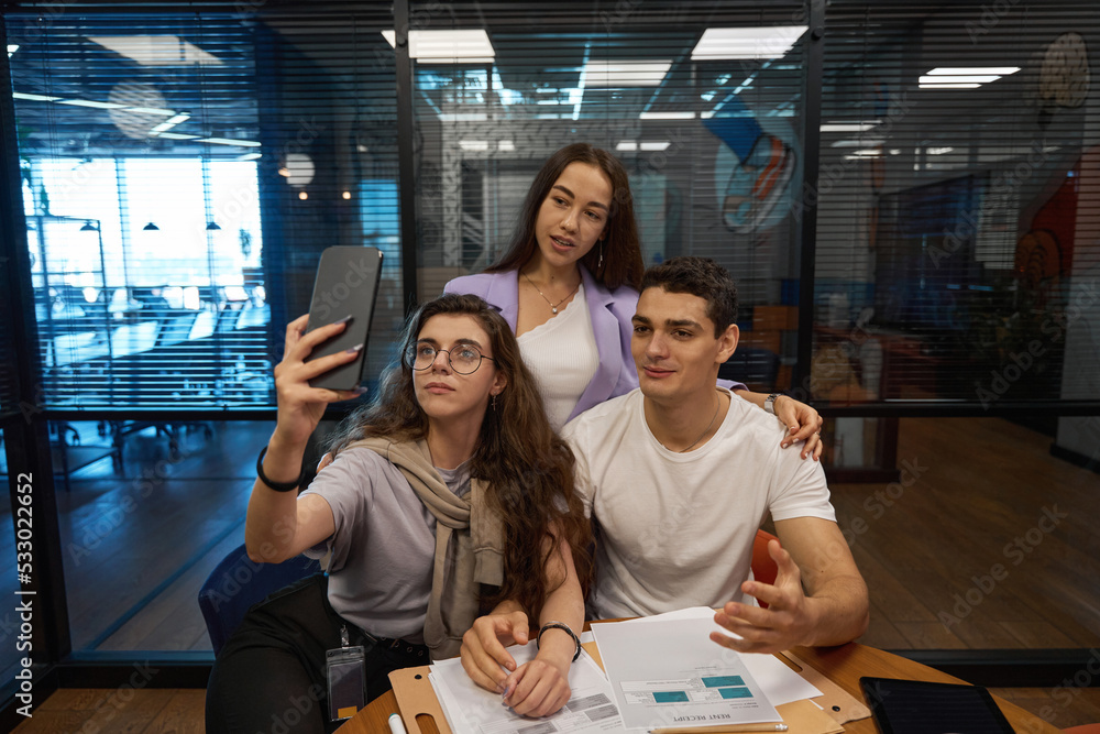 Man and two women are capturing their time on camera Man and two women are capturing their time on camera
