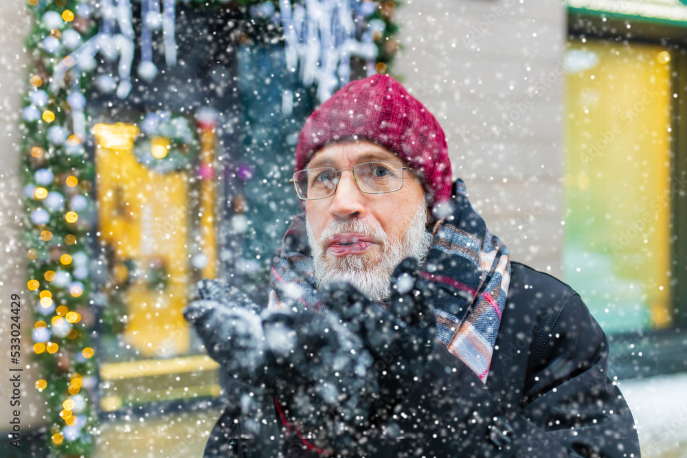 happy good looking mature man spending great winter time in city town happy good looking mature man spending great winter time in city town