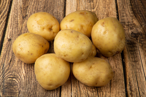 White potatoes on a wooden background.Fresh vegetables. Sale.