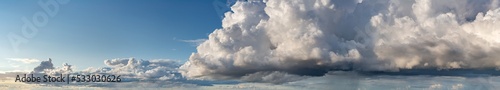 Fantastic clouds against blue sky  panorama
