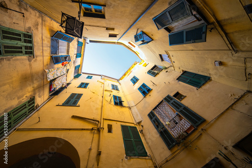 Typical houses facades of Taggia, small village of the Ligurian hinterland, on the slopes of the Maritime Alps (Imperia Province, Northern Italy). photo