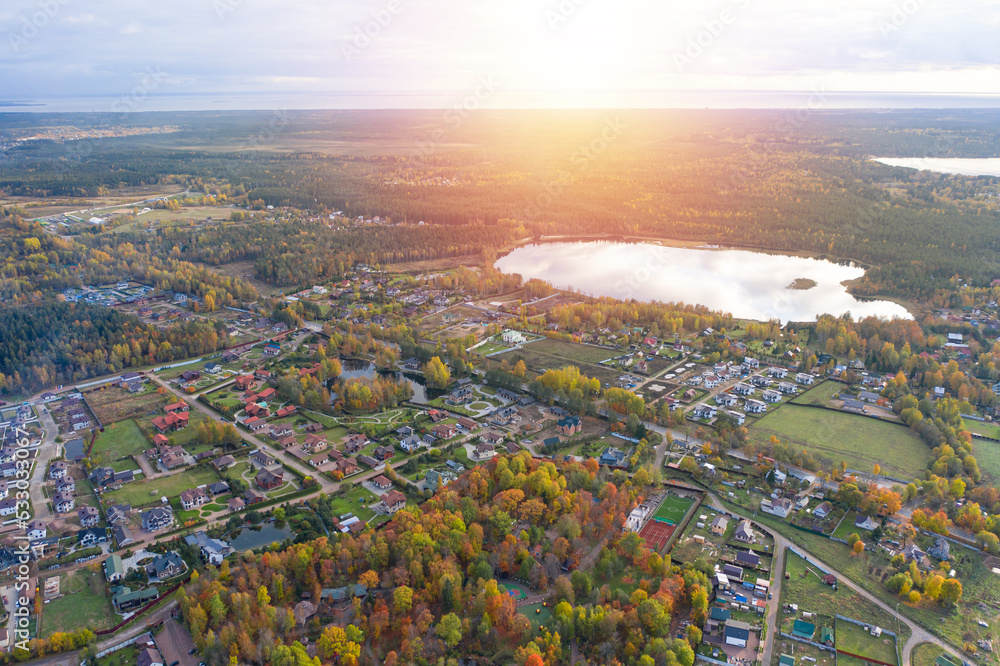Village with summer houses in Autumn forest. Aerial view