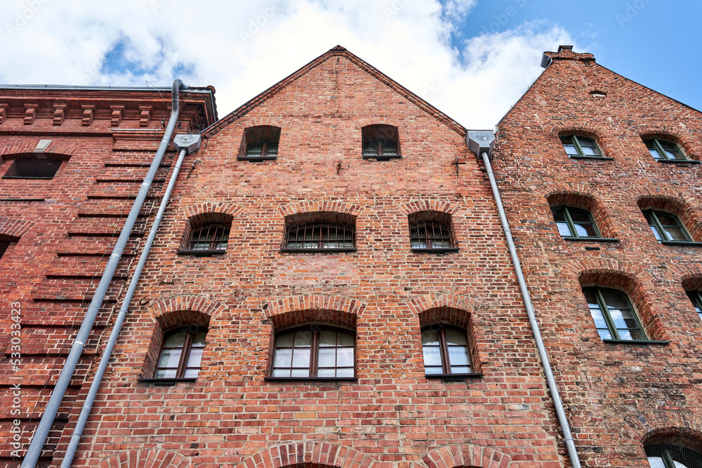 A facade with windows of a historic tenement house in the city of Torun A facade with windows of a historic tenement house in the city of Torun