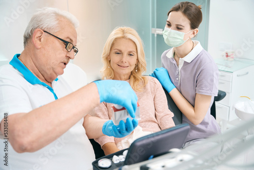 Woman on appointment with dentist in dental cabinet