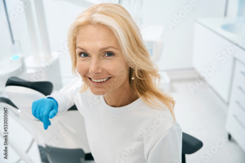 Smiling dentist in protective gloves at dental coach