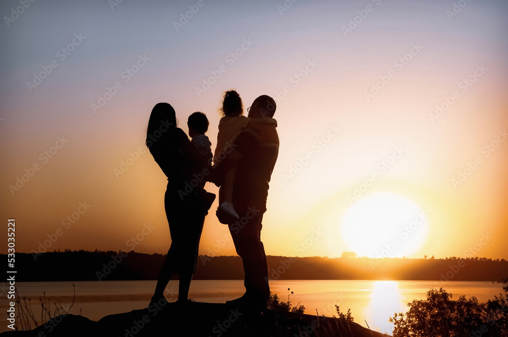 Family with children sunset walk by the river. High quality photo