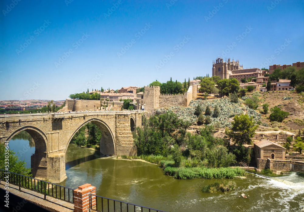 Panoramic view of old historical center and bridge Puente de San Martín in the city Toledo, Spain.