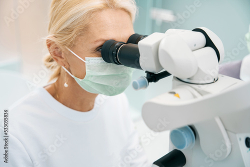 Laboratory assistant examines the results of research