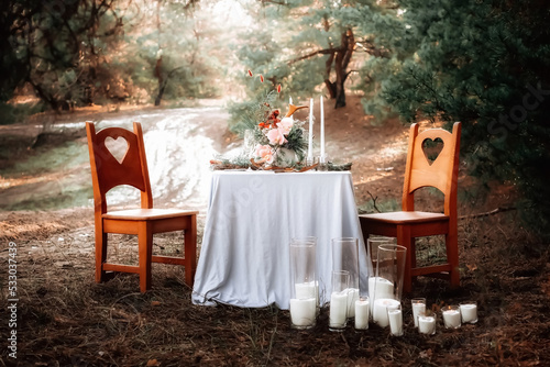 Romantic candlelit dinner in the autumn forest for lovers. High quality photo
