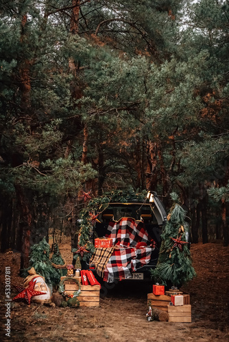 Christmas gifts in the winter forest by car. High quality photo
