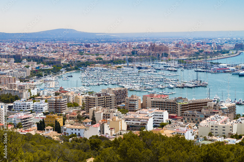Unique panoramic skyline view of Palma de Mallorca, and marina with yachts. Viewed in the background is La Seu Cathedral.