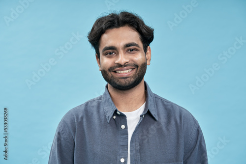 Canvas Print Smiling confident young adult arab man standing isolated on blue background