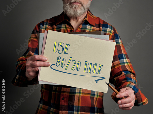 use 80/20 rule (Pareto principle) - concept presented by a senior male teacher or mentor with sketches on paper, business, productivity and priorities concept photo