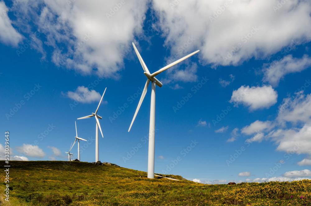 wind turbines against mountains and sky wind turbines against mountains and sky