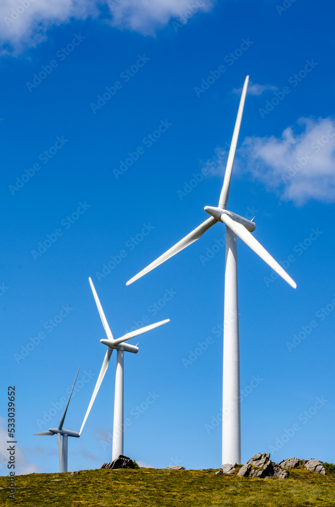 wind turbines against mountains and sky wind turbines against mountains and sky