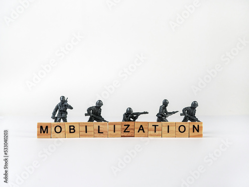 The word mobilization and soldiers on a light background. Mobilization in Russia.