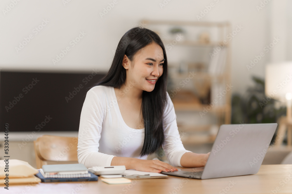 Happy smart asian woman freelancer working with laptop while live in the room. Happy smart asian woman freelancer working with laptop while live in the room.