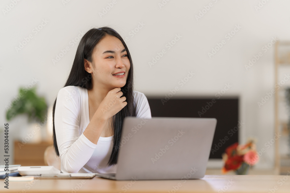 Happy smart asian woman freelancer working with laptop while live in the room. Happy smart asian woman freelancer working with laptop while live in the room.