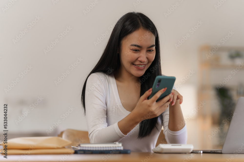 Portrait of smile asian woman freelancer using mobile phone at home office. Portrait of smile asian woman freelancer using mobile phone at home office.