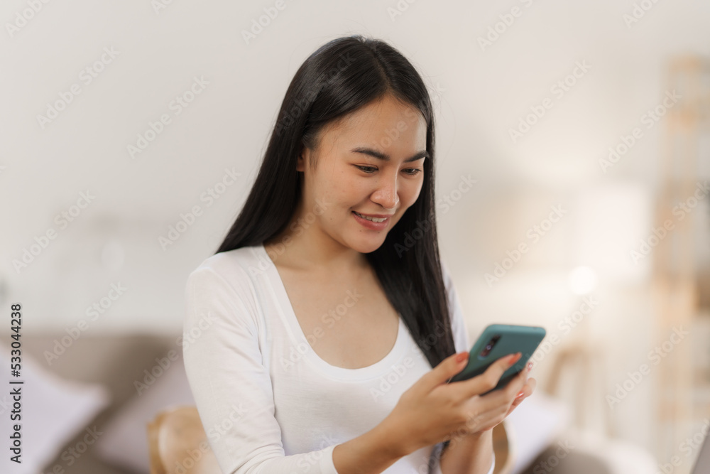 Portrait of smile asian woman freelancer using mobile phone at home office. Portrait of smile asian woman freelancer using mobile phone at home office.