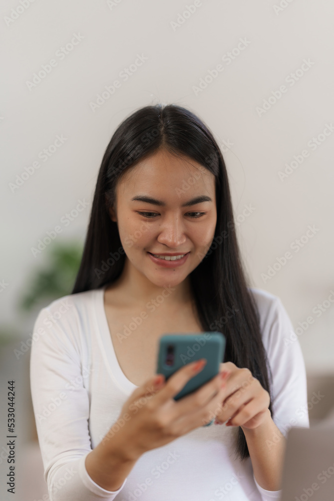 Portrait of smile asian woman freelancer using mobile phone at home office. Portrait of smile asian woman freelancer using mobile phone at home office.