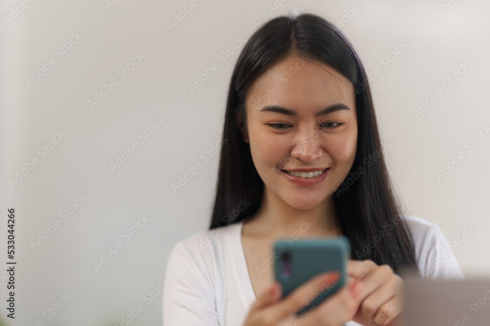 Portrait of smile asian woman freelancer using mobile phone at home office. Portrait of smile asian woman freelancer using mobile phone at home office.