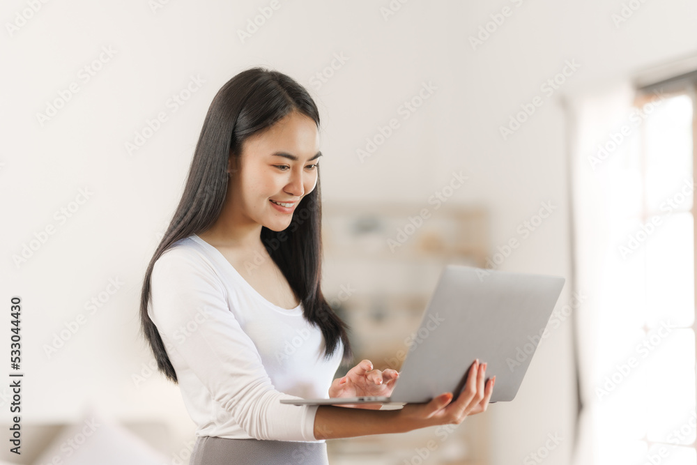 Happy smart asian woman freelancer working with laptop while live in the room. Happy smart asian woman freelancer working with laptop while live in the room.