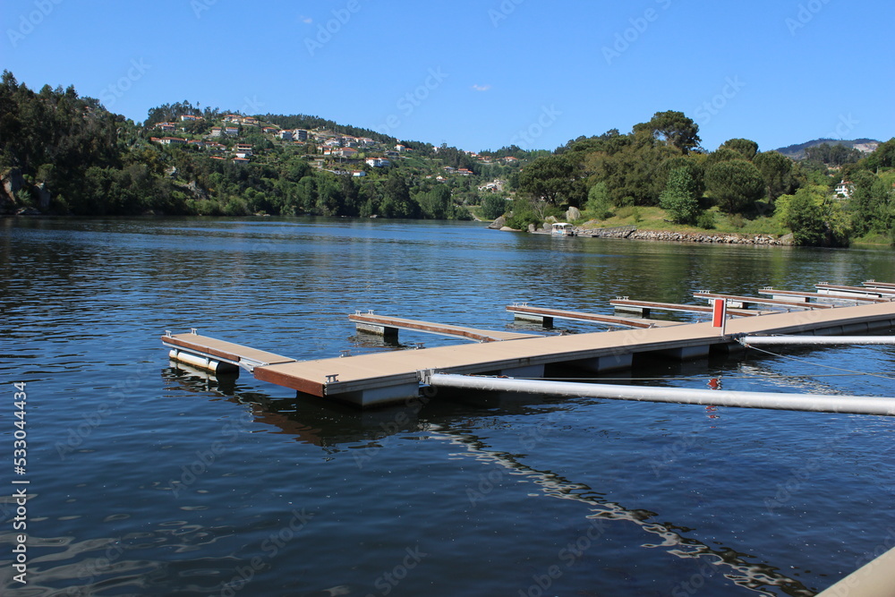 Obraz premium calm river with trees and blue sky