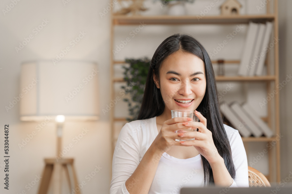 Confident smiling asian woman in creative home office looking at camera. Confident smiling asian woman in creative home office looking at camera.