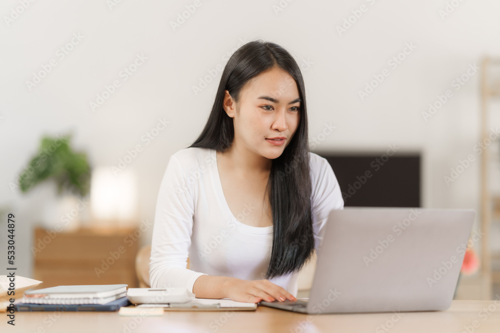Happy smart asian woman freelancer working with laptop while live in the room. Happy smart asian woman freelancer working with laptop while live in the room.