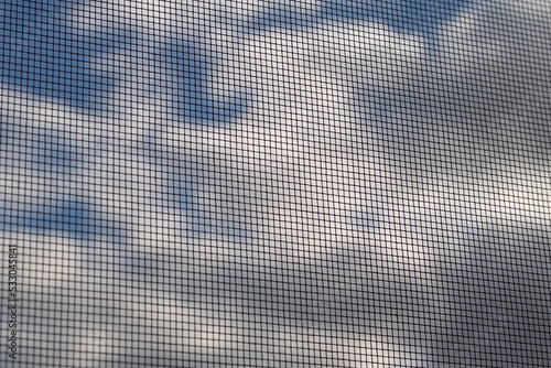 Mosquito net against insects on the background of a cloudy sky.