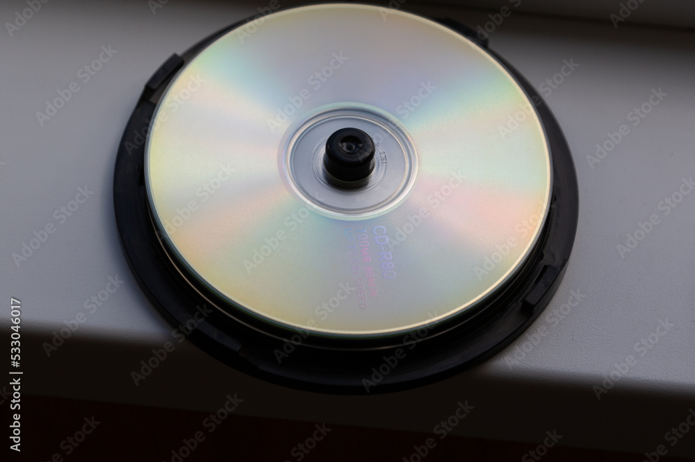 CD on a white window sill in daylight. For data storage. CD on a white window sill in daylight. For data storage.