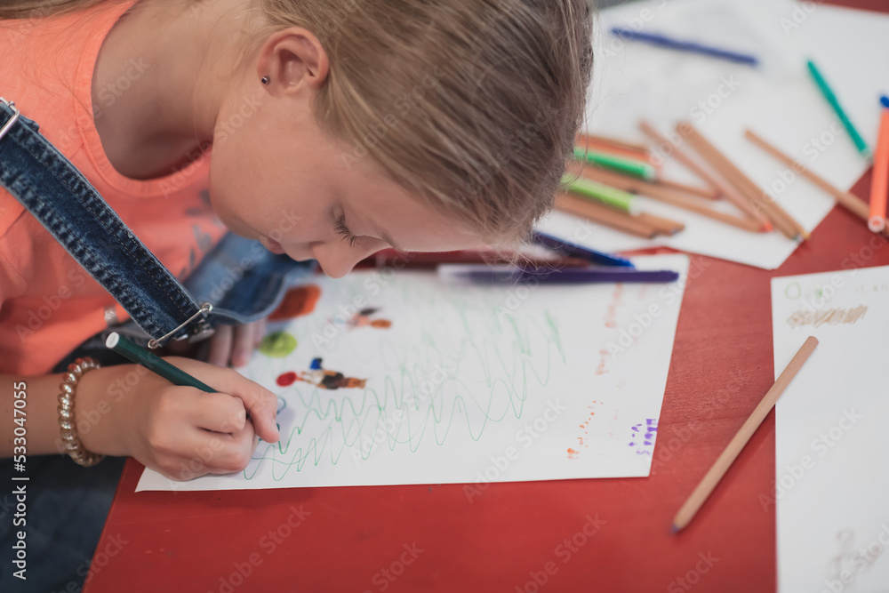 Creative kids sitting in a preschool institution, draw and have fun while they get an education Creative kids sitting in a preschool institution, draw and have fun while they get an education