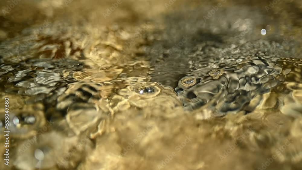 Closeup of water from a mountain river in summer (slow motion, bokeh) Closeup of water from a mountain river in summer (slow motion, bokeh)