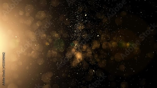 Gold particles falling on black background in Slow Motion Animation. Shiny Christmas golden lights 4K. photo