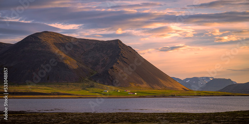Mountainous landscape in Iceland at sunset with a lake in the foreground