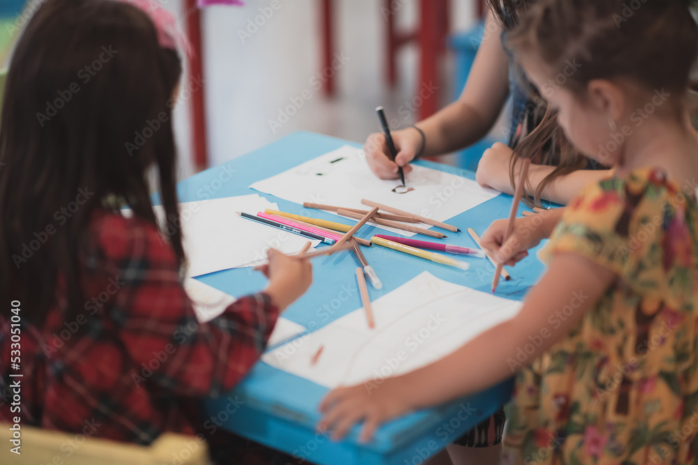 Creative kids sitting in a preschool institution, draw and have fun while they get an education - obrazy, fototapety, plakaty 