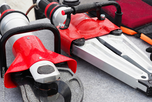 Foto Hydraulic rescue tools, hydraulic shears and spreader for saving people from damaged cars in road accidents