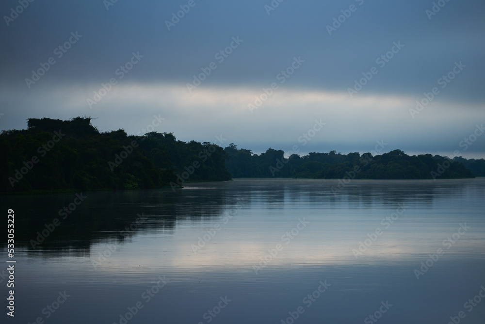 Moody dawn on the Guaporé - Itenez river, near the remote village of Cafetal, Beni Department, Bolivia, on the border with Rondonia state, Brazil Moody dawn on the Guaporé - Itenez river, near the remote village of Cafetal, Beni Department, Bolivia, on the border with Rondonia state, Brazil