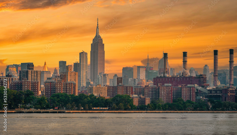 city skyline at sunset beautiful New York City manhattan urban panorama skyscrapers sky color orange buildings park river love 