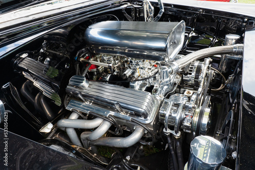 Muscle Car Engine with dual carburetors, headers and lots of shiny chrome.