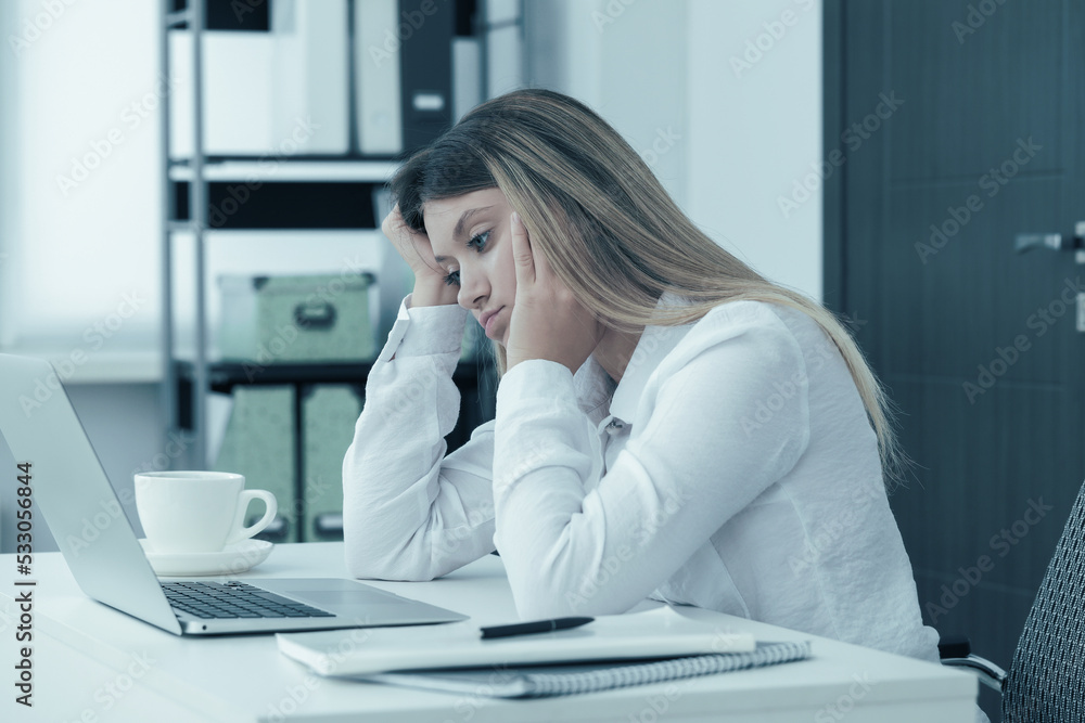 Sleepy young woman at workplace in office Sleepy young woman at workplace in office