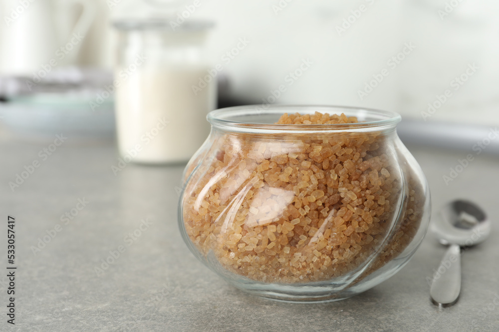 Glass bowl with brown sugar on grey table Glass bowl with brown sugar on grey table
