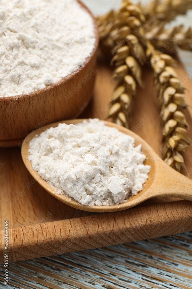 Organic wheat flour on wooden table, closeup Organic wheat flour on wooden table, closeup