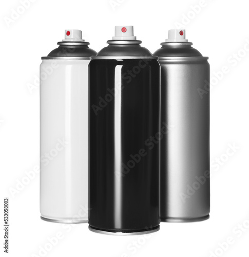 Cans of spray paints on white background