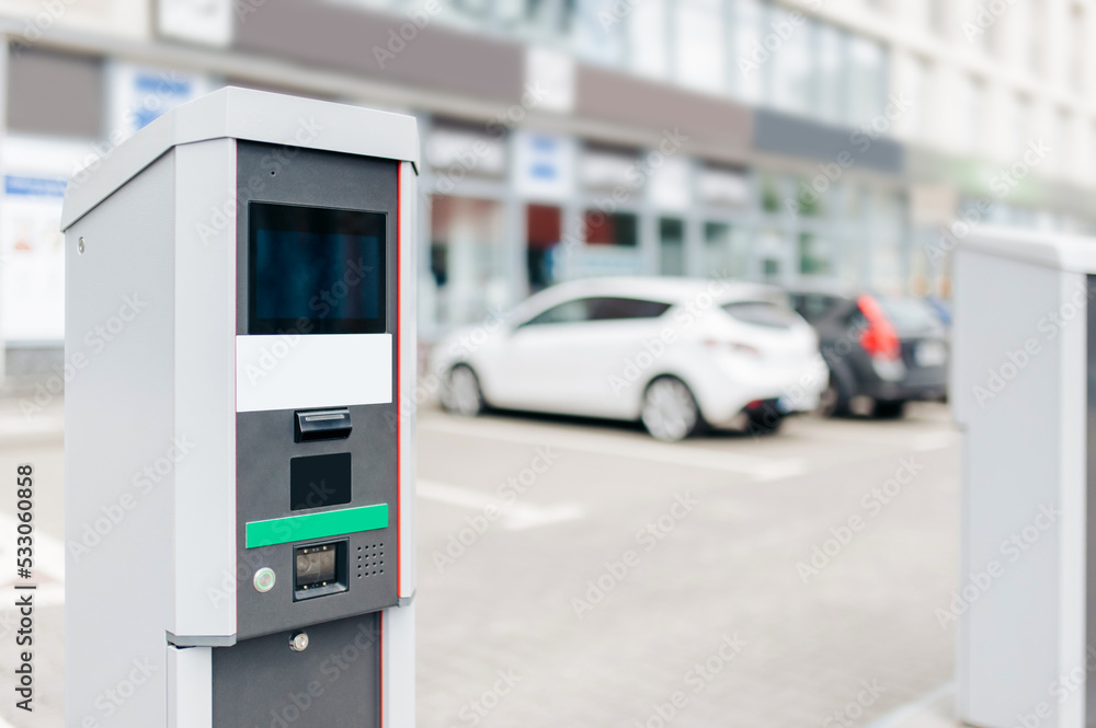 Modern parking meter on city street. Space for text Modern parking meter on city street. Space for text