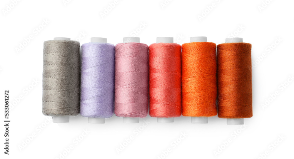 Set of different colorful sewing threads on white background, top view Set of different colorful sewing threads on white background, top view