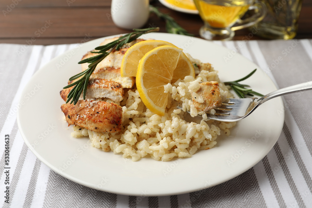 Delicious chicken risotto with lemon on table, closeup Delicious chicken risotto with lemon on table, closeup
